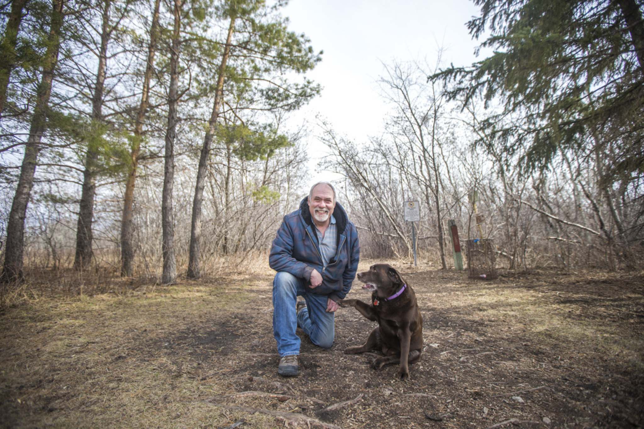 MIKAELA MACKENZIE / WINNIPEG FREE PRESS Lloyd Johnson, founder of the Little Mountain Park Pet Owners Association, poses for a portrait at the park with his dog, Sage, in Winnipeg on Friday, April 9, 2021. For Joyanne Pursaga story. Winnipeg Free Press 2020.